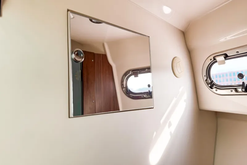  Yacht Photos Pics Interior of 2016 Pursuit OS 355 Offshore boat with mirror and porthole window.
