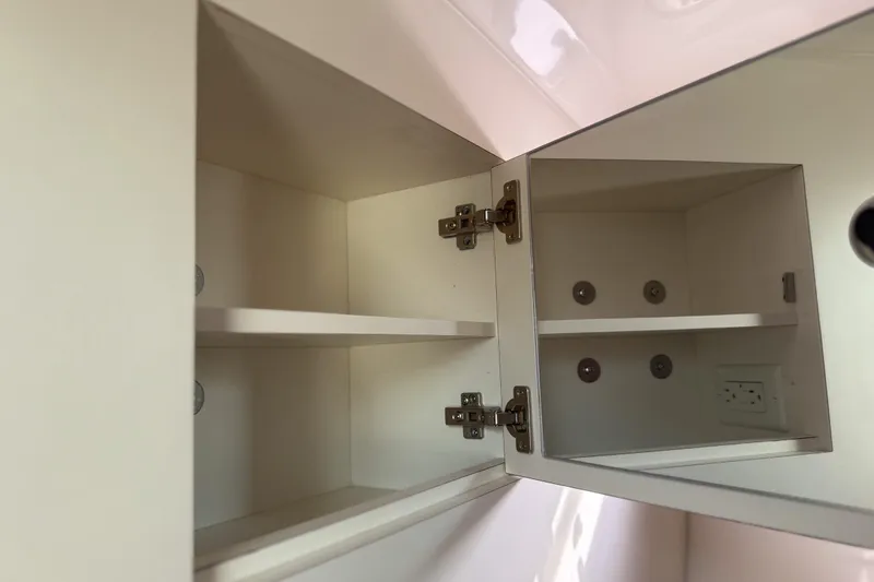  Yacht Photos Pics Open cabinet with shelves inside a 2016 Pursuit OS 355 Offshore boat.