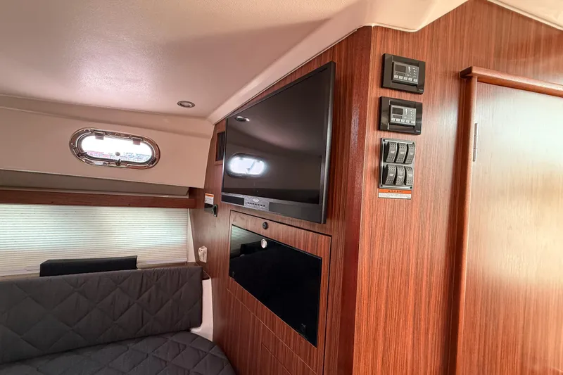  Yacht Photos Pics Interior of 2016 Pursuit OS 355 Offshore boat with wood paneling and modern amenities.