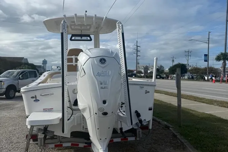  Yacht Photos Pics 2025 Regulator 26XO boat with powerful 450 V8 engine, parked near a road.