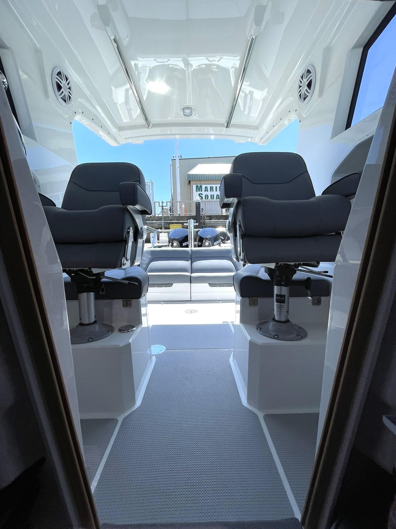 Interior view of 2024 Protector 310 Targa boat with two cushioned seats.