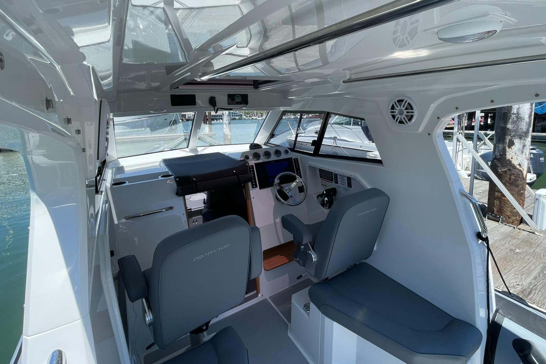 2024 Protector 310 Targa boat interior with modern helm and seating.