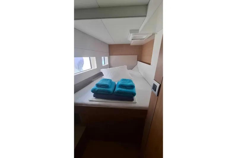 Zoie Yacht Photos Pics Luxurious cabin interior of 2025 Bali CATSMART yacht with neatly arranged turquoise towels.
