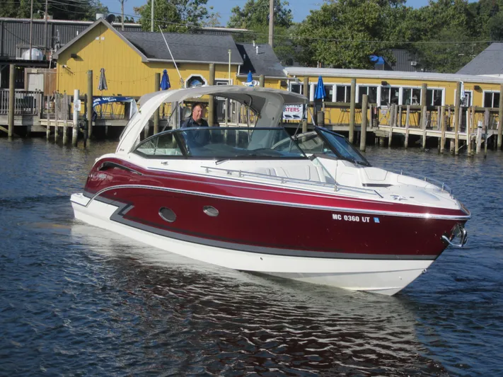  Yacht Photos Pics 2019 Formula 350 Crossover Bowrider cruising near a dockside restaurant.