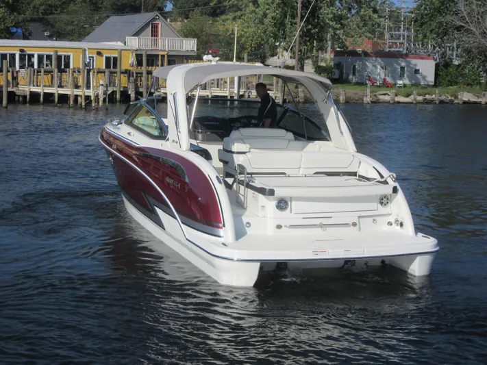  Yacht Photos Pics 2019 Formula 350 Crossover Bowrider on a calm lake near a dock.