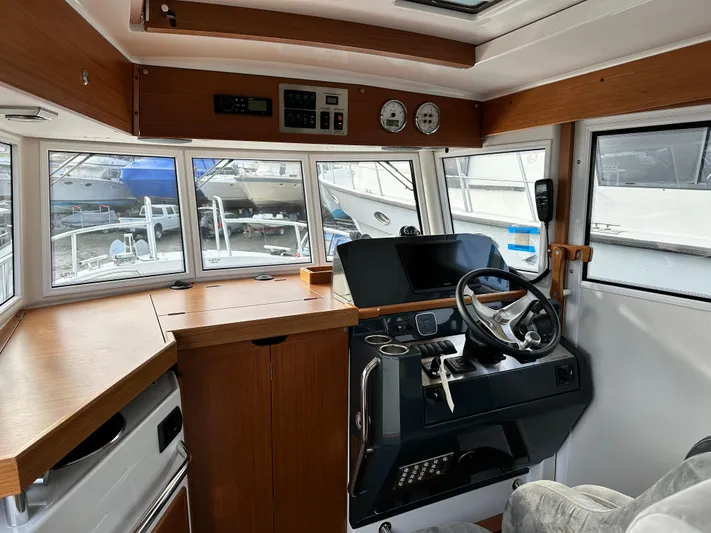  Yacht Photos Pics Interior of 2023 Sargo 28 boat, featuring modern helm and wooden cabinetry.
