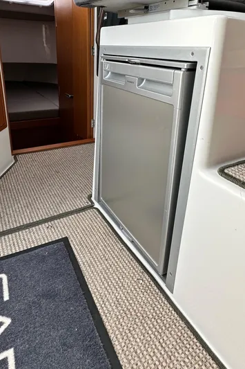  Yacht Photos Pics Compact kitchen area in 2023 Sargo 28 boat with modern fridge.