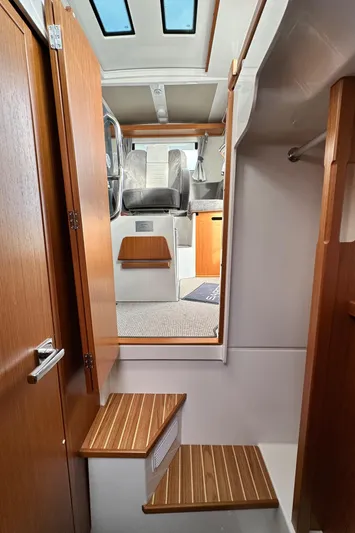  Yacht Photos Pics Interior view of 2023 Sargo 28 boat with wooden steps and modern design.