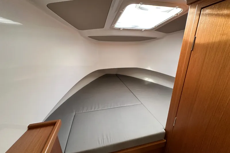  Yacht Photos Pics 2023 Sargo 28 cabin interior with gray cushions and wooden accents.