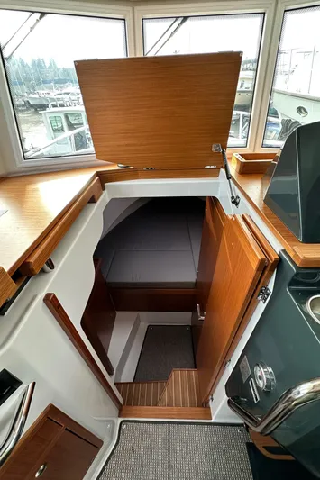  Yacht Photos Pics 2023 Sargo 28 boat interior with wooden cabinetry and open hatch.