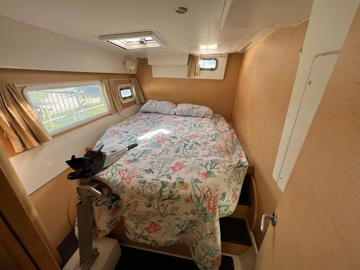 Anita Jo Yacht Photos Pics Interior cabin of 2008 Lagoon 420 catamaran with cozy bed and floral bedding.