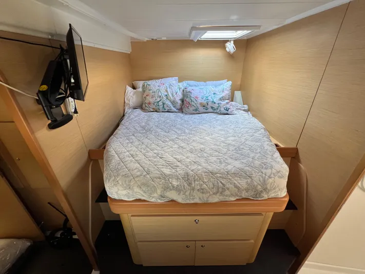 Anita Jo Yacht Photos Pics Cozy bedroom in 2008 Lagoon 420 catamaran with bed, pillows, and wall-mounted TV.