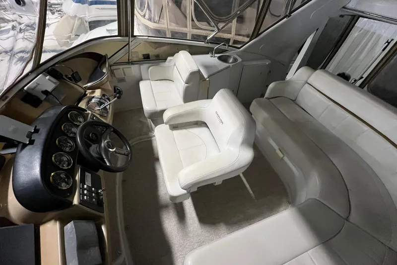 Yacht Photos Pics 2001 Carver 396 Motor Yacht interior with helm, white seating, and dashboard.