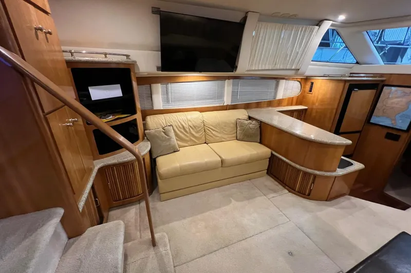  Yacht Photos Pics Interior of 2001 Carver 396 Motor Yacht with beige sofa and wooden cabinetry.