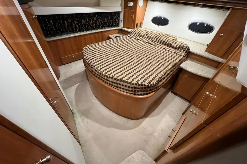  Yacht Photos Pics Luxurious 2001 Carver 396 Motor Yacht bedroom with elegant wood finish and cozy bed.