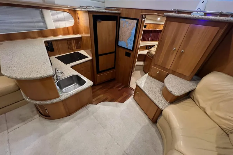  Yacht Photos Pics Interior of 2001 Carver 396 Motor Yacht with kitchen, seating, and wood cabinetry.