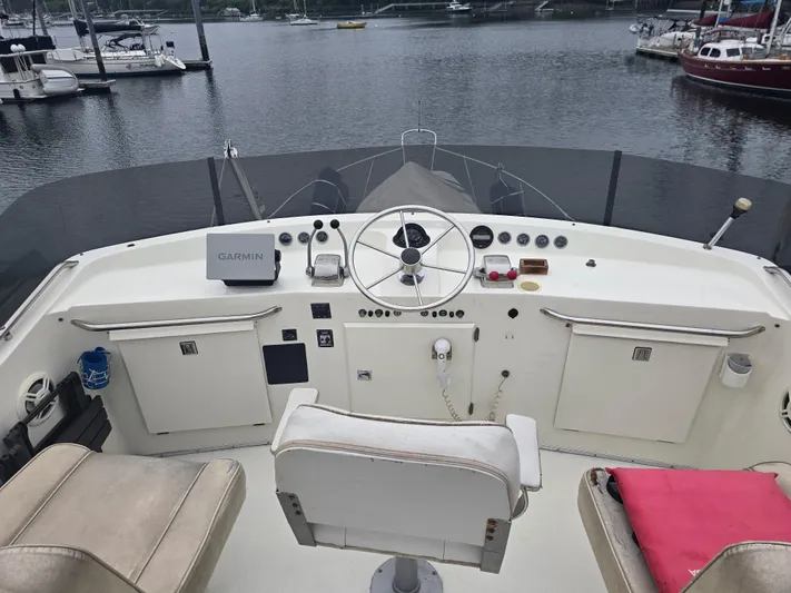 Aurora Yacht Photos Pics 1982 Tollycraft 37 Sportfish Convertible helm with Garmin navigation, docked at marina.