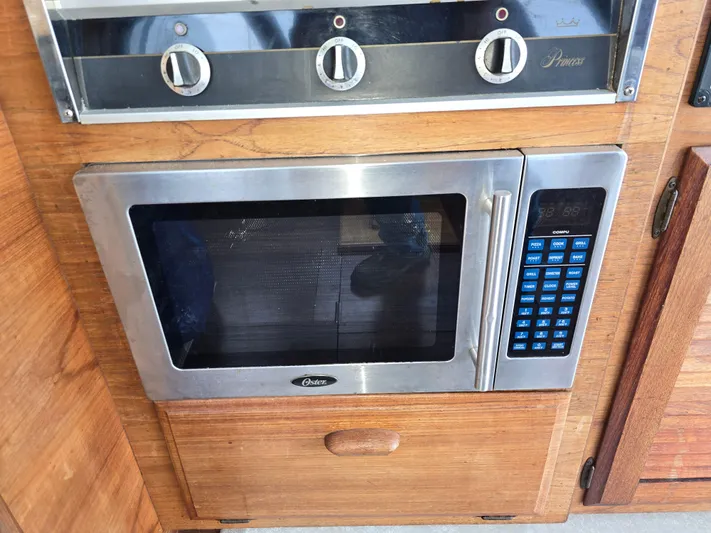 Aurora Yacht Photos Pics Microwave and stove controls in 1982 Tollycraft 37 Sportfish/Convertible yacht kitchen.