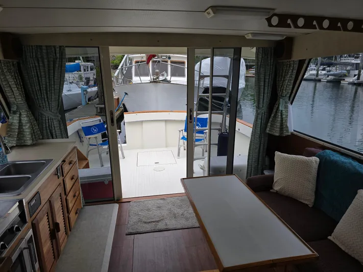 Aurora Yacht Photos Pics Interior view of 1982 Tollycraft 37 Sportfish Convertible yacht, featuring cozy seating and kitchenette.