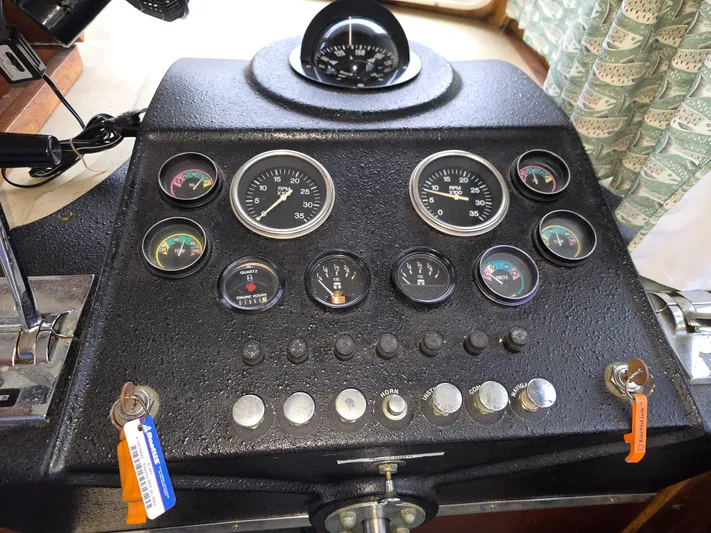 Aurora Yacht Photos Pics Control panel of a 1982 Tollycraft 37 Sportfish/Convertible boat with gauges and switches.