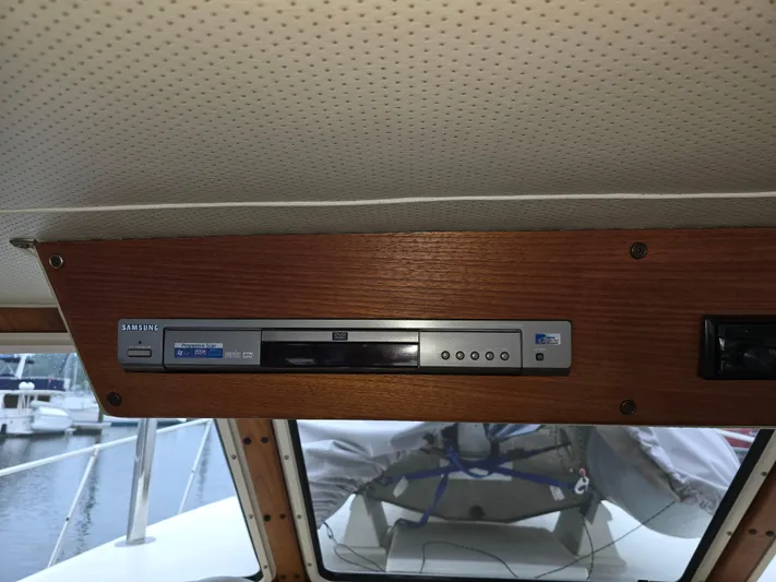Aurora Yacht Photos Pics 1982 Tollycraft 37 Sportfish interior with Samsung DVD player installed in wooden panel.