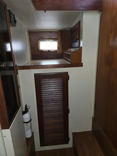 Aurora Yacht Photos Pics 1982 Tollycraft 37 Sportfish Convertible interior with wooden cabinetry and window.