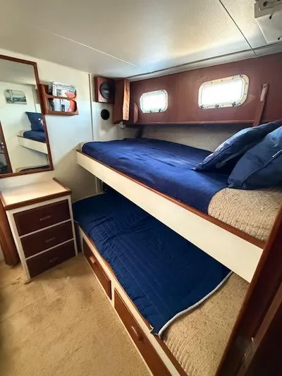 Aurora Yacht Photos Pics 1982 Tollycraft 37 Sportfish Convertible cabin with bunk beds and nautical decor.