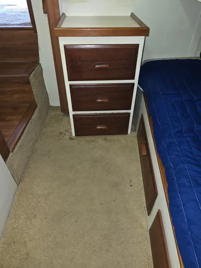 Aurora Yacht Photos Pics Interior of 1982 Tollycraft 37 Sportfish with drawers and blue bedding.