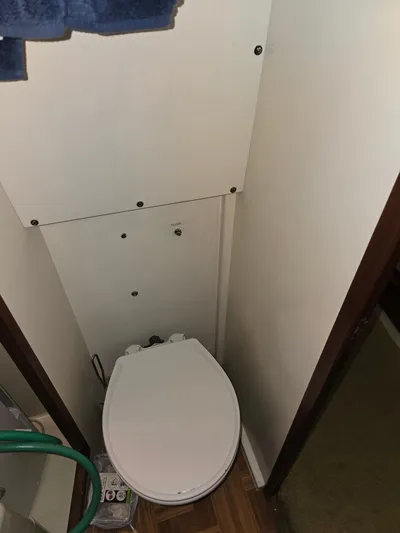 Aurora Yacht Photos Pics 1982 Tollycraft 37 Sportfish Convertible bathroom with toilet and wooden flooring.