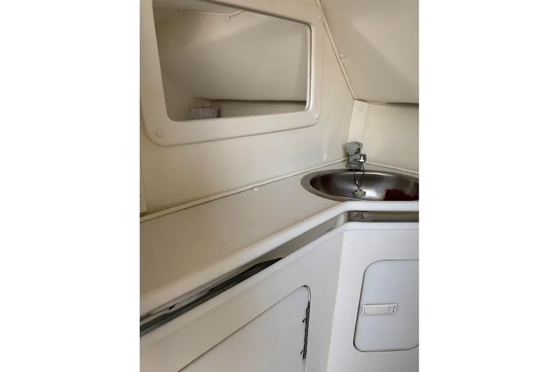 Grabbn Air Yacht Photos Pics 1997 Fountain 42 Lightning boat interior with sink and storage area.