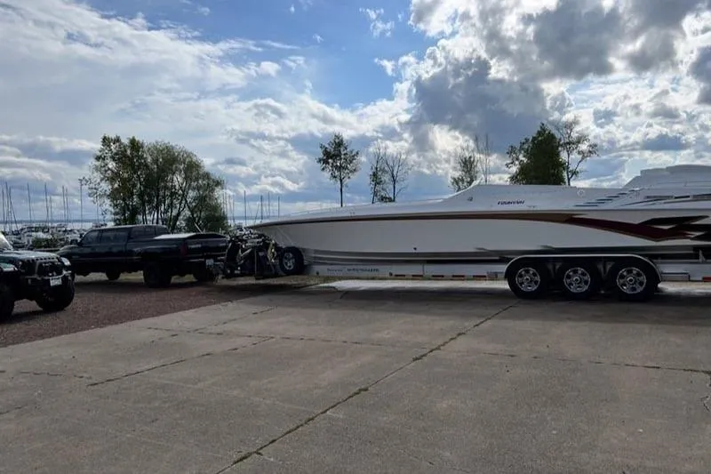 Grabbn Air Yacht Photos Pics 1997 Fountain 42 Lightning boat on trailer, parked outdoors under cloudy sky.