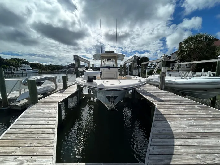  Yacht Photos Pics 2023 Grady-White 281 Coastal Explorer docked under cloudy sky.