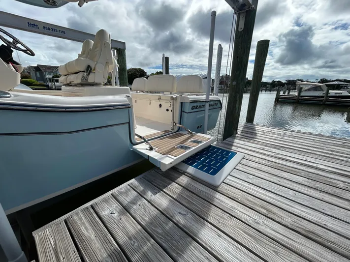  Yacht Photos Pics 2023 Grady-White 281 Coastal Explorer docked, showcasing sleek design and spacious seating.