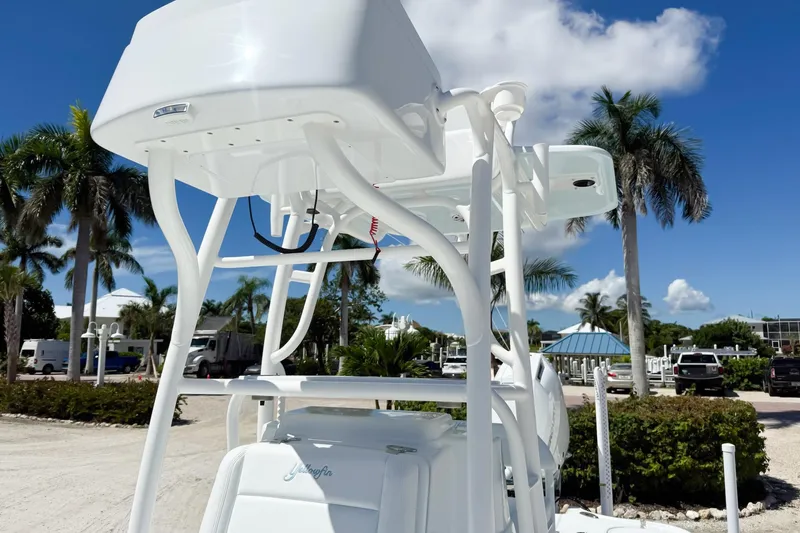  Yacht Photos Pics 2026 Yellowfin 24 Bay CE boat with T-top, parked near palm trees under blue sky.