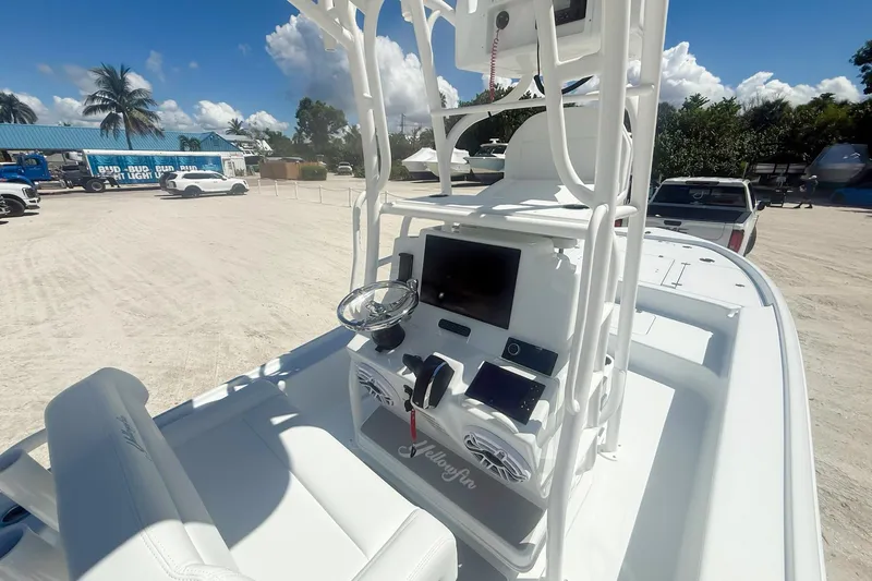  Yacht Photos Pics 2026 Yellowfin 24 Bay CE boat dashboard with steering wheel and electronic displays.