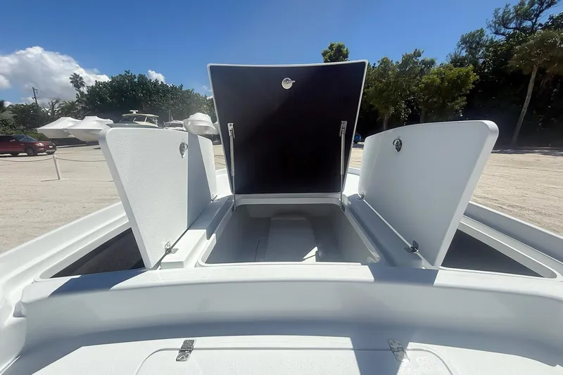  Yacht Photos Pics 2026 Yellowfin 24 Bay CE boat storage compartments open under clear sky.