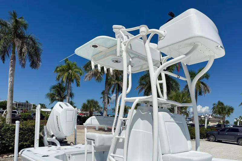  Yacht Photos Pics 2026 Yellowfin 24 Bay CE boat with tower, set against a tropical backdrop.