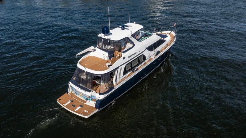 Just A Dream Yacht Photos Pics 2005 Carver 56 Voyager yacht cruising on open water, aerial view.