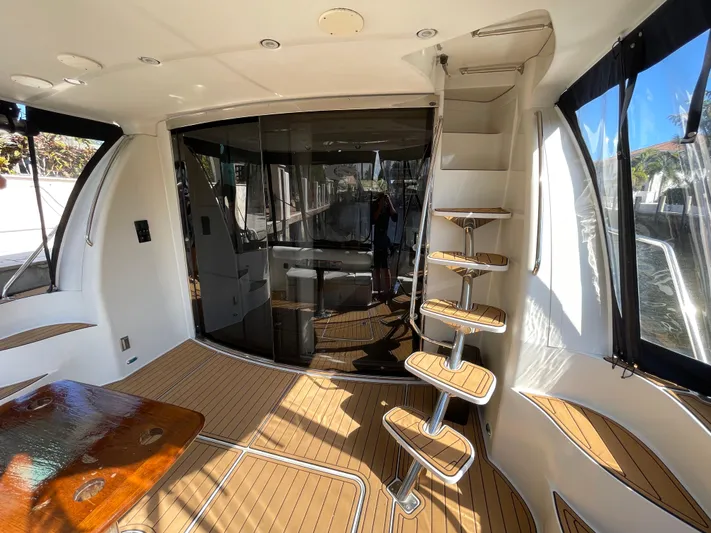 Just A Dream Yacht Photos Pics Interior of 2005 Carver 56 Voyager yacht with wooden flooring and spiral staircase.