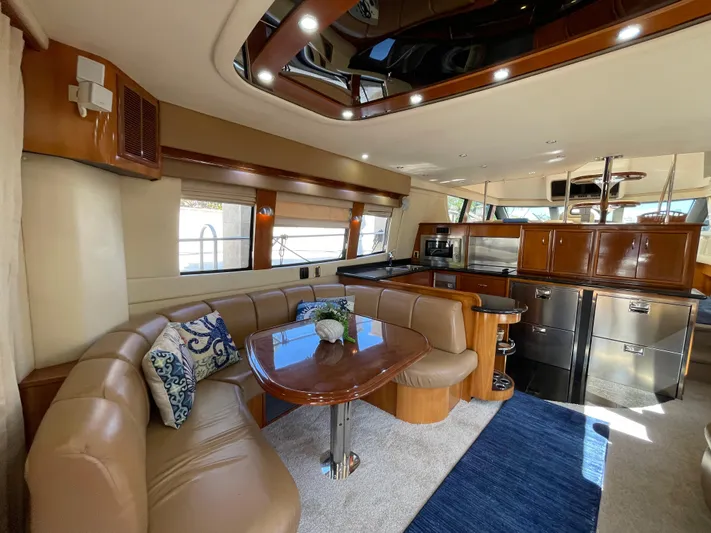 Just A Dream Yacht Photos Pics Luxurious interior of 2005 Carver 56 Voyager yacht with elegant seating and modern kitchen.