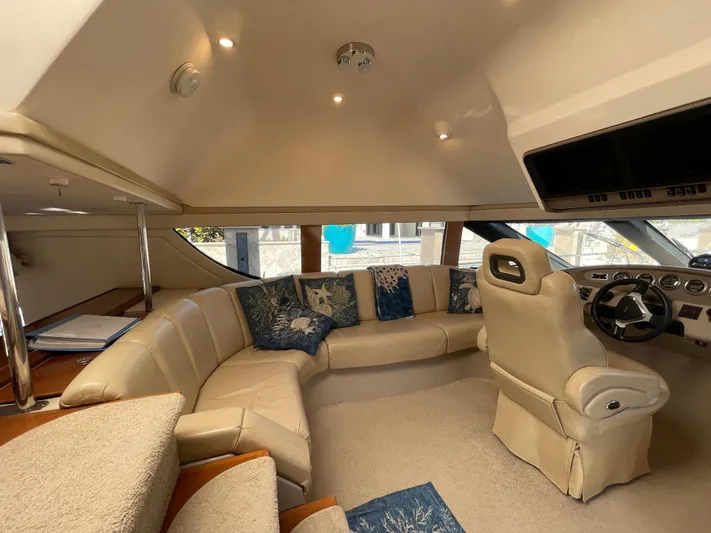 Just A Dream Yacht Photos Pics Luxurious interior of 2005 Carver 56 Voyager yacht with plush seating and modern helm.