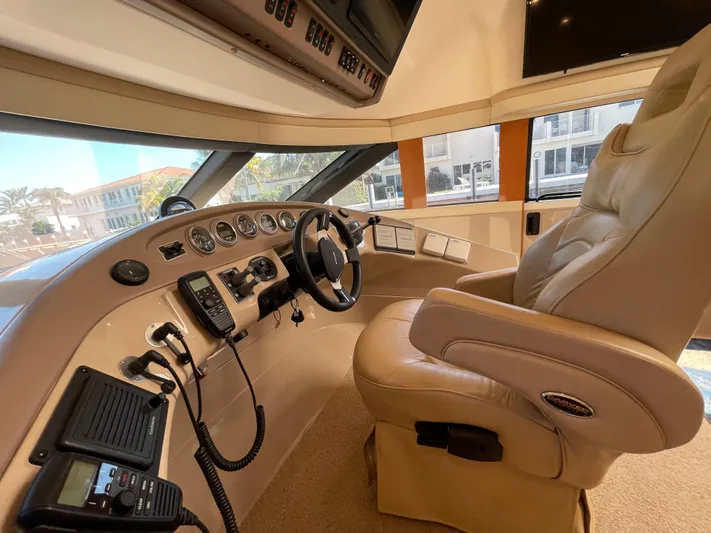 Just A Dream Yacht Photos Pics Captain's helm of 2005 Carver 56 Voyager yacht with leather seat and control panel.