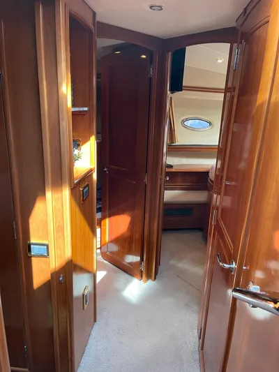 Just A Dream Yacht Photos Pics Interior of 2005 Carver 56 Voyager yacht with wooden cabinetry and carpeted flooring.