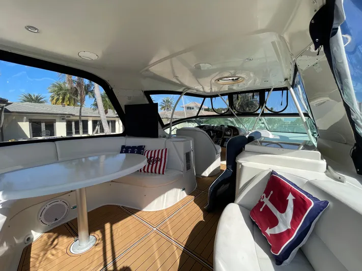 Just A Dream Yacht Photos Pics 2005 Carver 56 Voyager yacht interior with seating, table, and nautical-themed pillows.