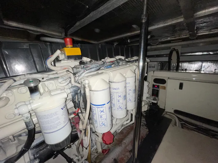 Just A Dream Yacht Photos Pics Engine room of a 2005 Carver 56 Voyager yacht, showcasing filters and mechanical components.