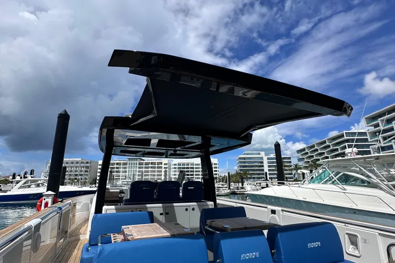 Uni Yacht Photos Pics 2020 Fjord 44 Open yacht with sleek design docked at marina under blue sky.