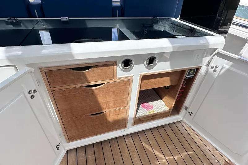 Uni Yacht Photos Pics Interior of 2020 Fjord 44 Open yacht with wooden cabinetry and storage compartments.