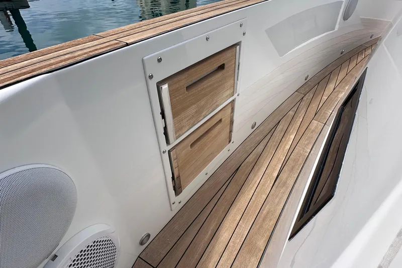Uni Yacht Photos Pics 2020 Fjord 44 Open yacht deck with wooden flooring and storage compartments.