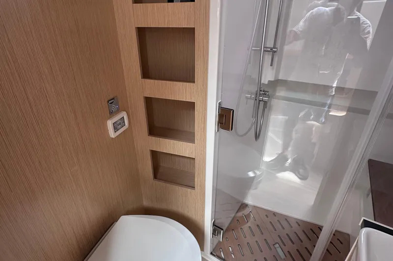 Uni Yacht Photos Pics Bathroom interior of 2020 Fjord 44 Open yacht with shower and wooden shelving.