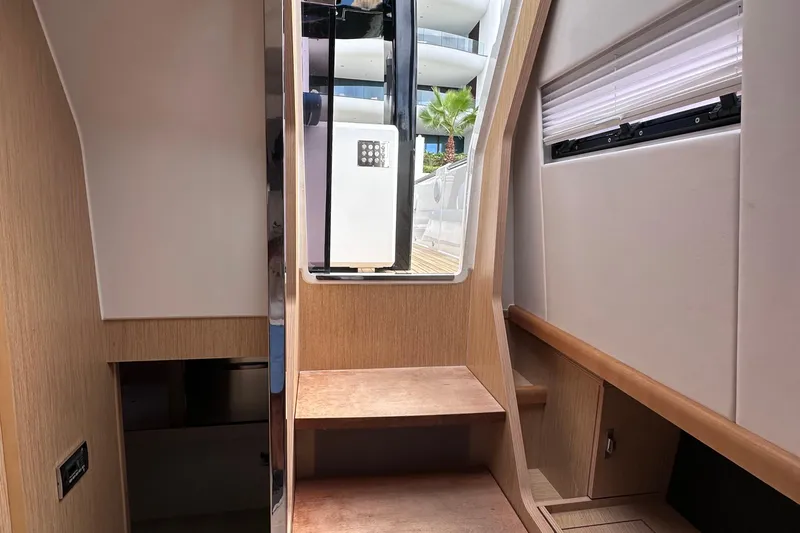 Uni Yacht Photos Pics Interior view of 2020 Fjord 44 Open yacht with wooden steps and modern design.
